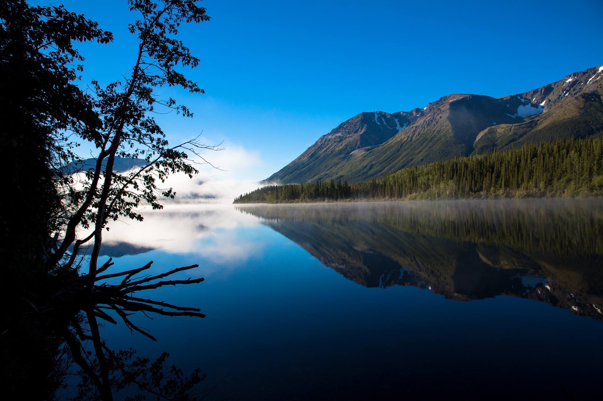 Morning mist and mountain reflections on Kluachon Lake at Iskut, on the Stewart Cassiar Highway